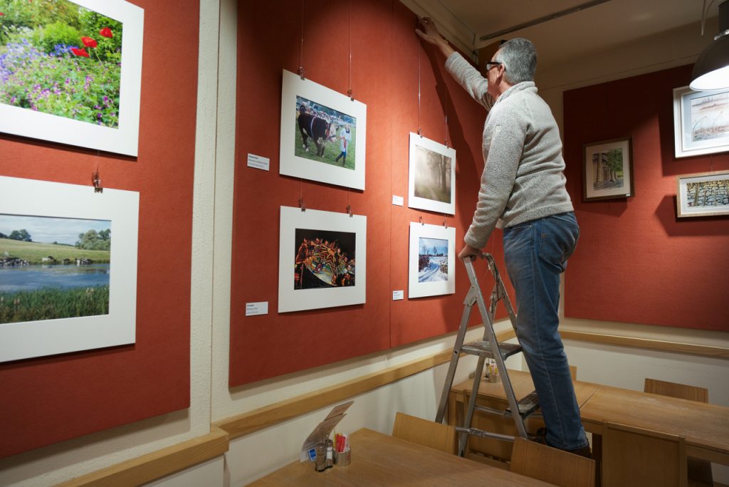 Member's Photos go on the Wall at Café Red